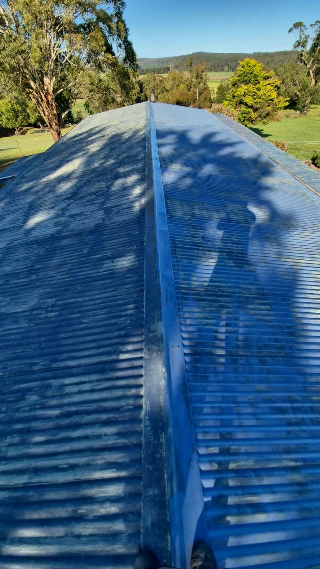 Oxidised, weathered corrugated metal roof before restoration