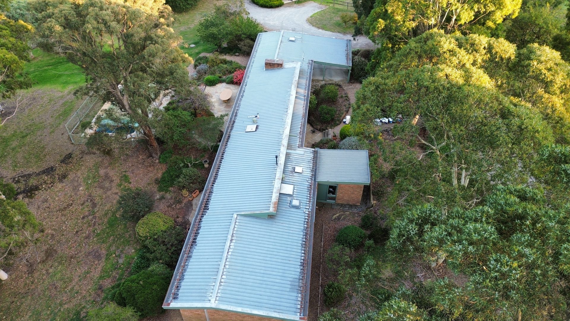 Long country Colorbond roof oxidised and silver — before restoration