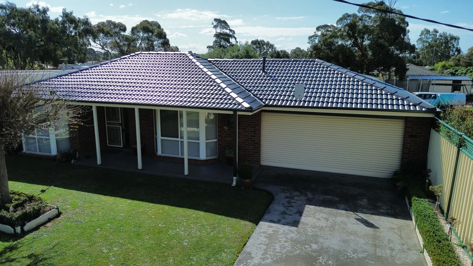 brick home with a freshly restored charcoal tile roof, Gippsland VIC