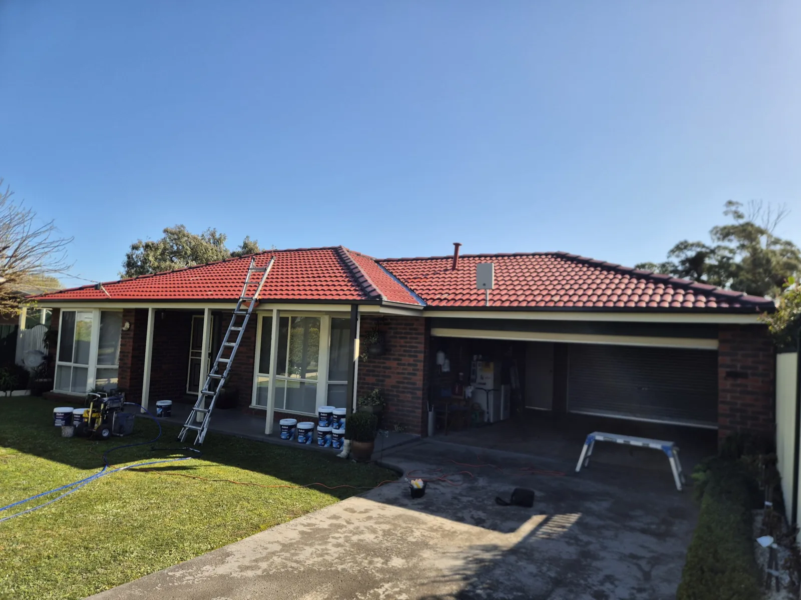 tiled roof being repainted red with Dulux products by Elite Roofing Restorations, Gippsland VIC
